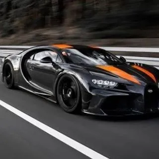 a black and orange sports car on a road